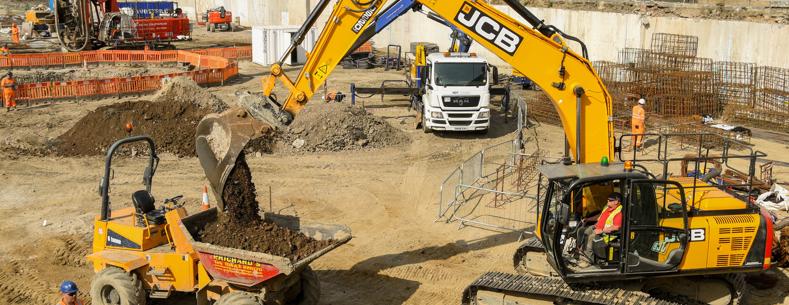 Gwaith adeiladu yn digwydd ar safle adeiladu.