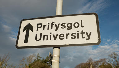Road sign indicating university ahead