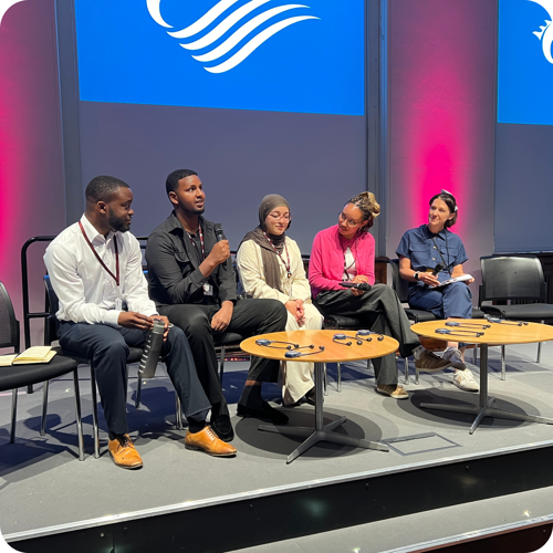 Interns from the YMLAEN scheme on stage in the Pierhead talking about their experiences at the Senedd.